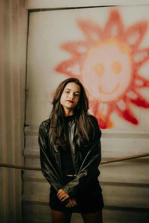 a young lady wearing leather is posing for a po