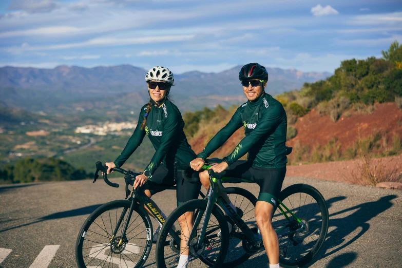 two people on bicycles posing for a po