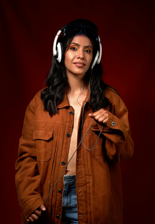 the woman wearing headphones is posing in a pose