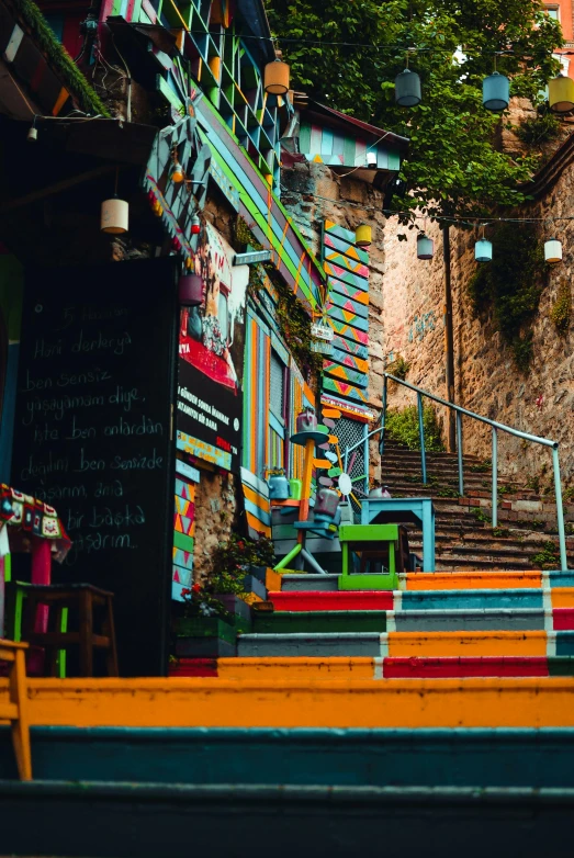 colorful painted steps lead to outdoor restaurant at dusk