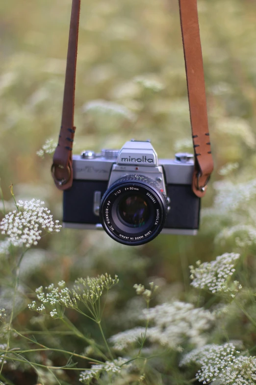 a camera sitting on top of a leather strap