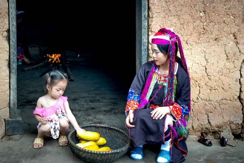 the little girl is selling fruit to her mother