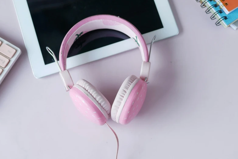 headphones on a desk and an electronic tablet