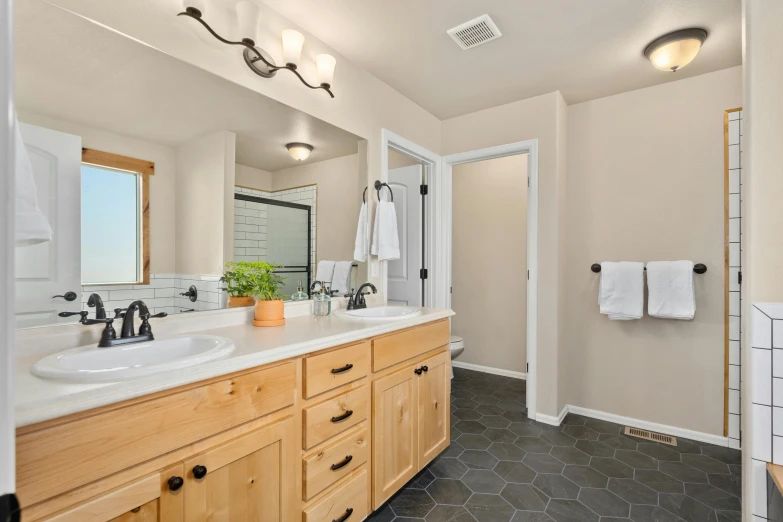 a large bathroom with double sinks and an open door