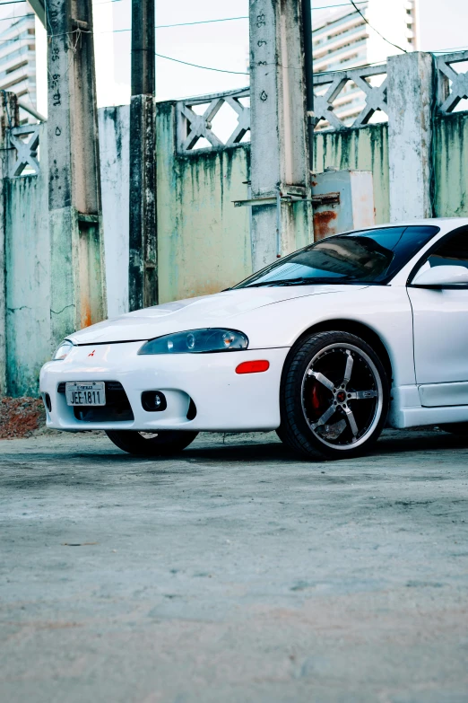 a white car parked on top of a cement road