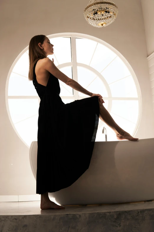 a young woman is sitting in a bathtub