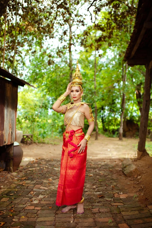 a woman wearing a costume posing on bricks