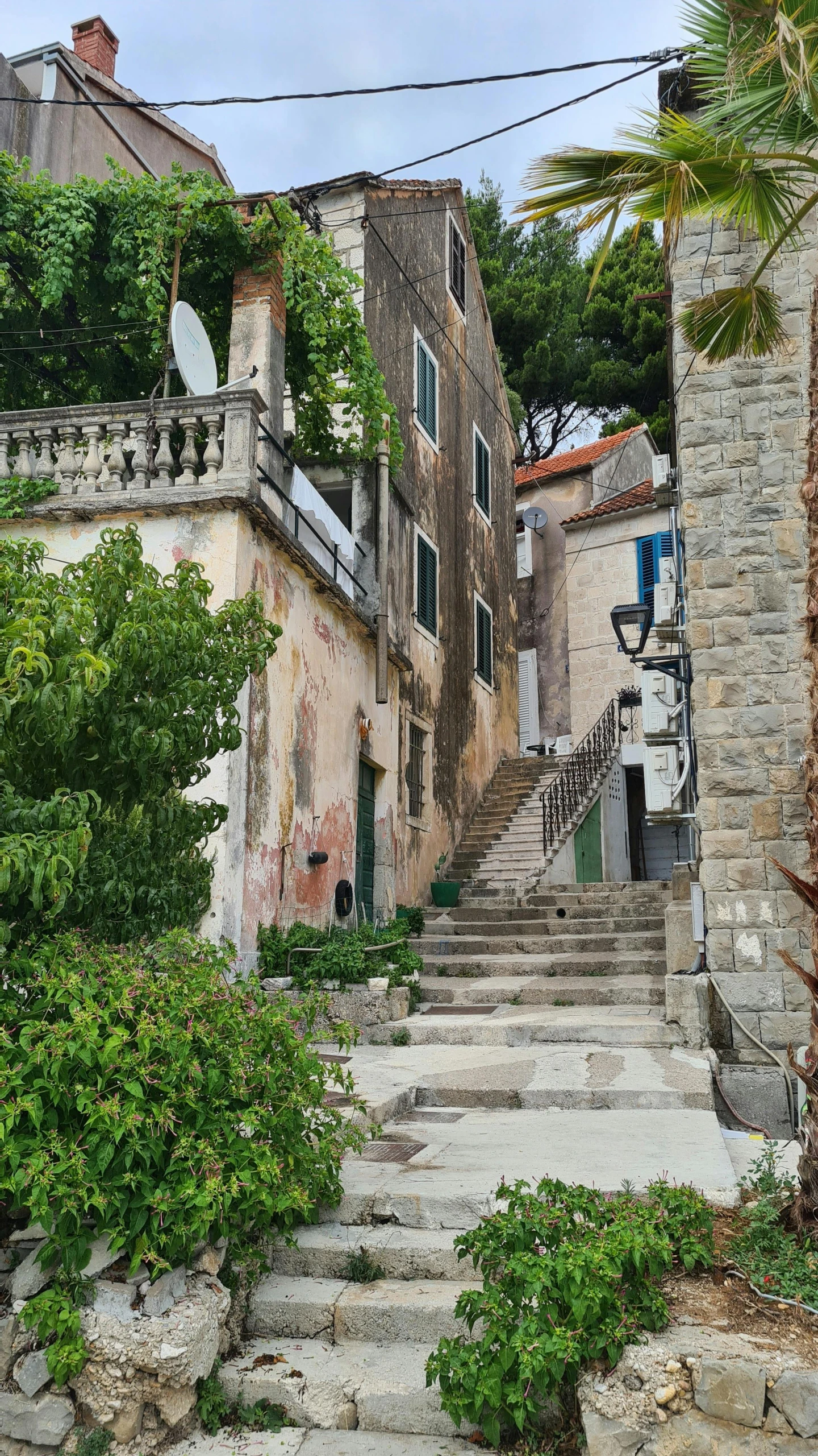 a staircase leads up to a stone house on a hill