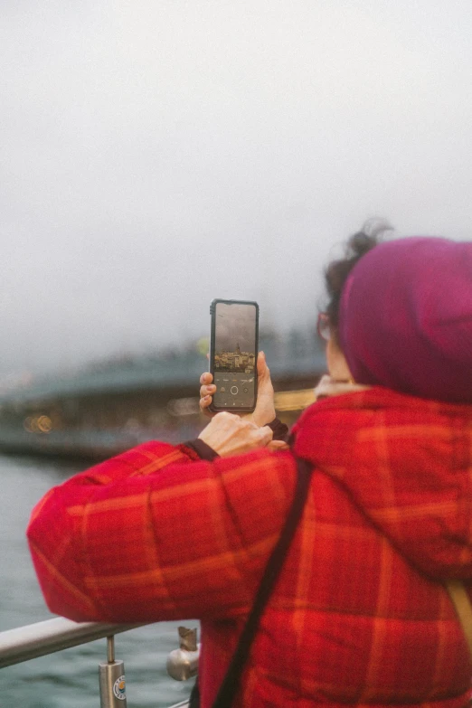 a person in red and red coat taking a po