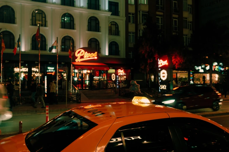 cars and people in an urban area at night