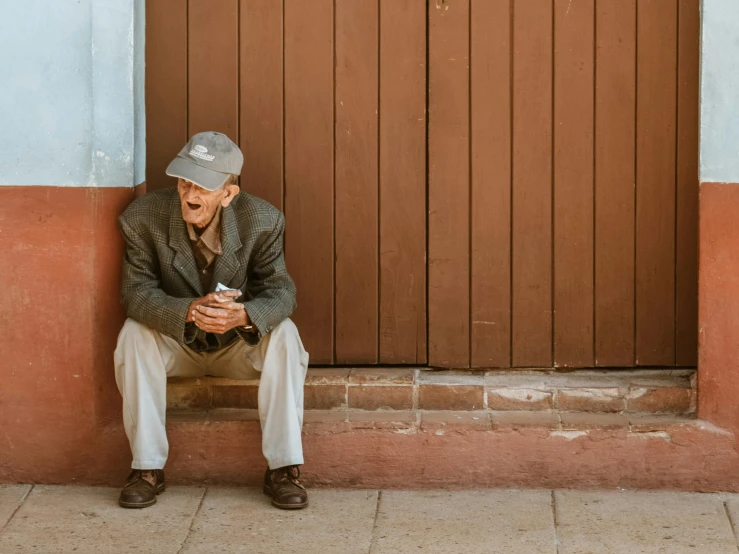 a man sitting on steps using his cell phone