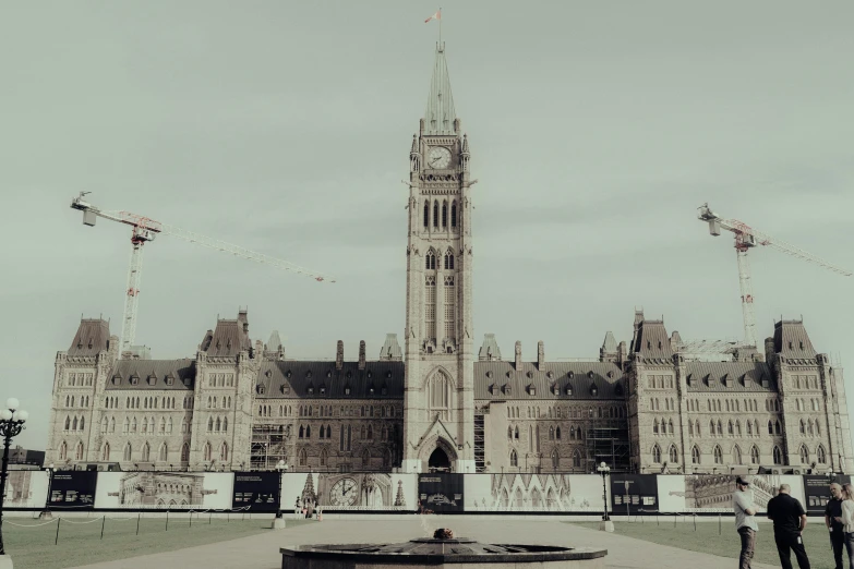 a large stone building with clock towers towering over a city