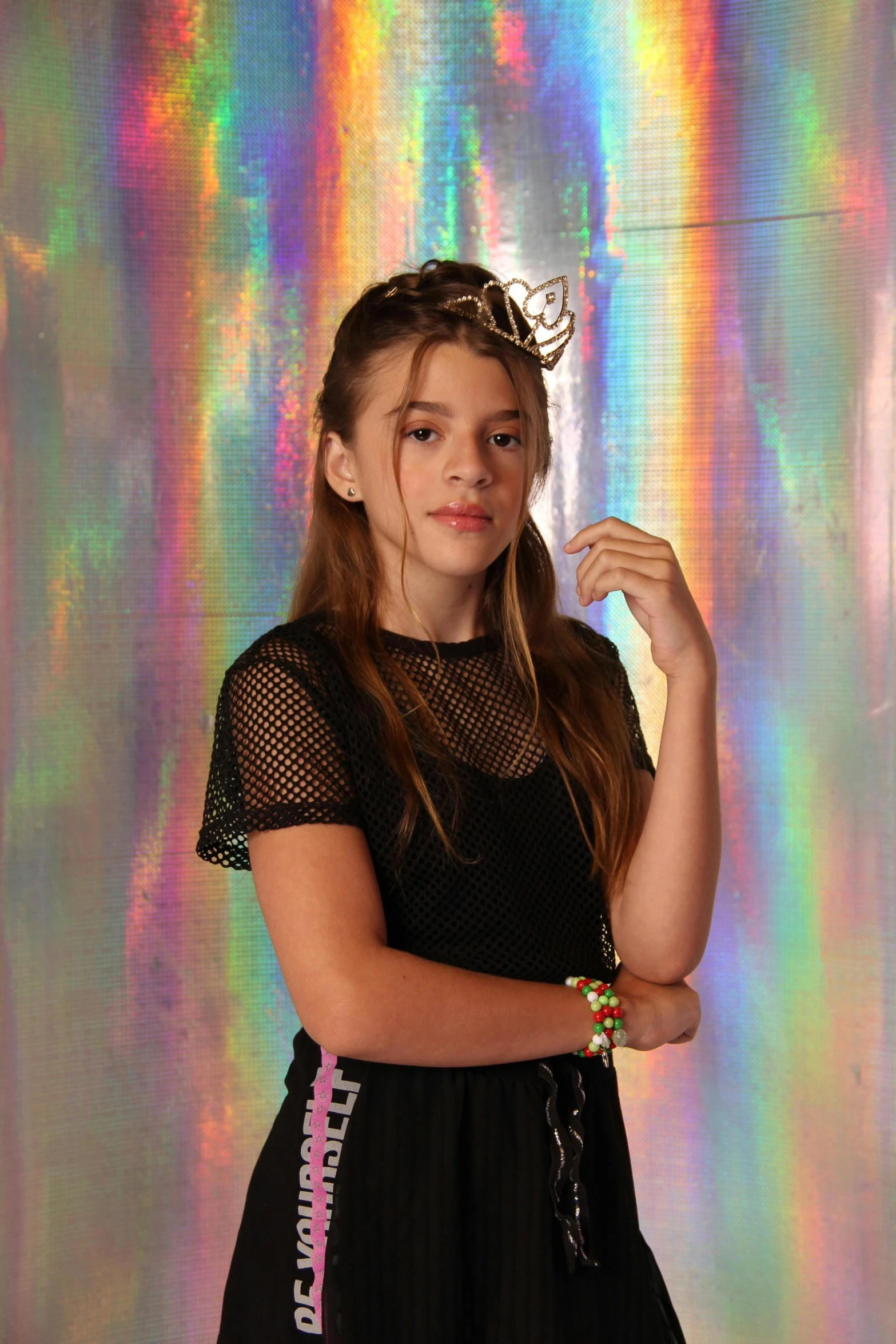 a girl wearing a black dress in front of holographic background