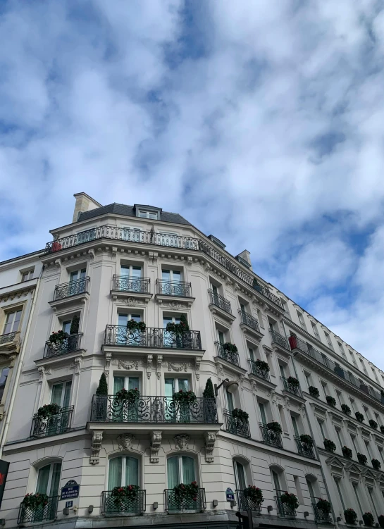 a tall building sitting in front of a cloudy sky