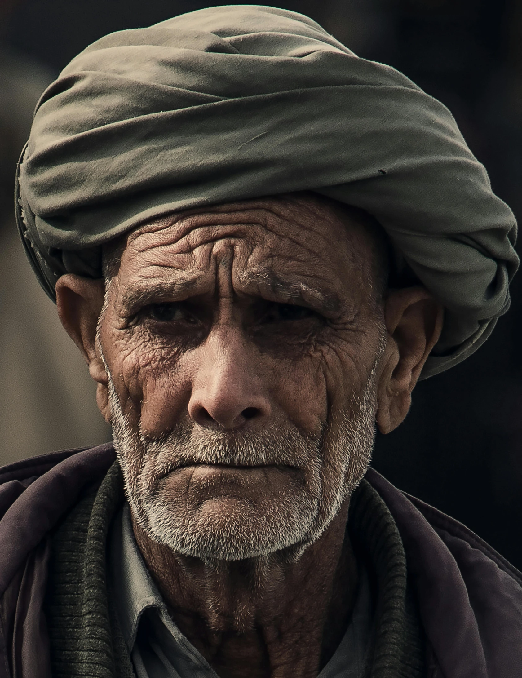 a person wearing a turban and standing near a building