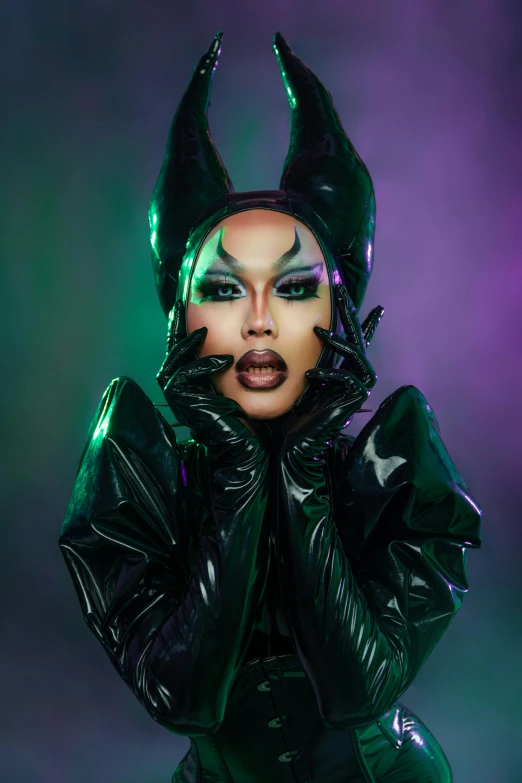 a woman with horns is wearing latex makeup