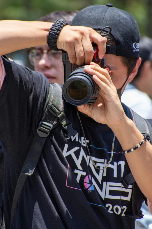 a man holding a camera up to take a po