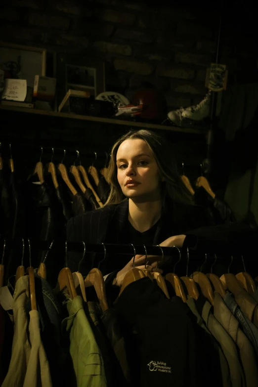 a girl is looking through her clothes in the dark