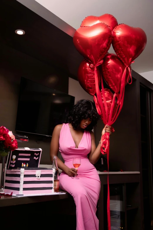 a woman holding a bunch of heart shaped balloons