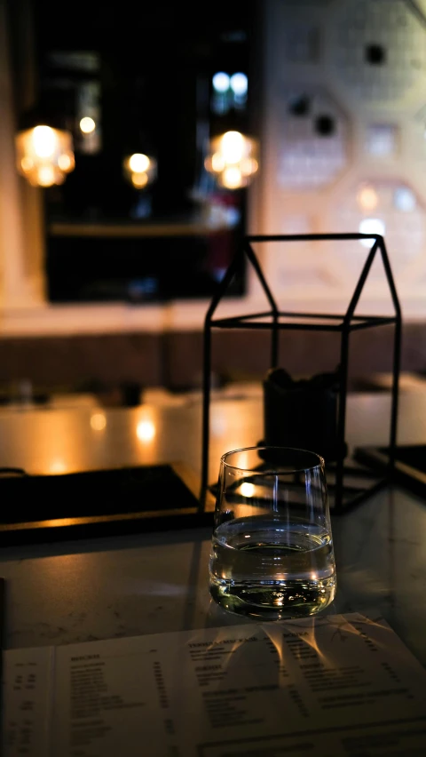 a clear glass with a liquid in it sitting on a table