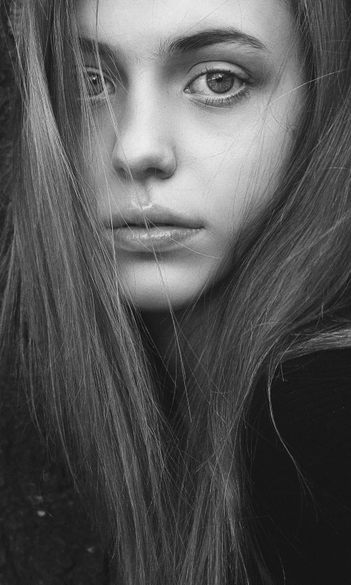 a woman with long hair in black and white