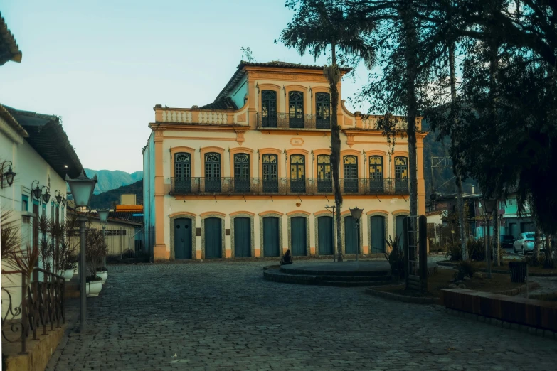 this is a city street with buildings and tall trees