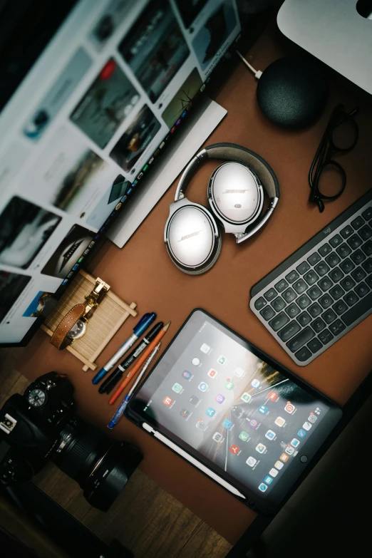 a brown desk covered in electronics and pos