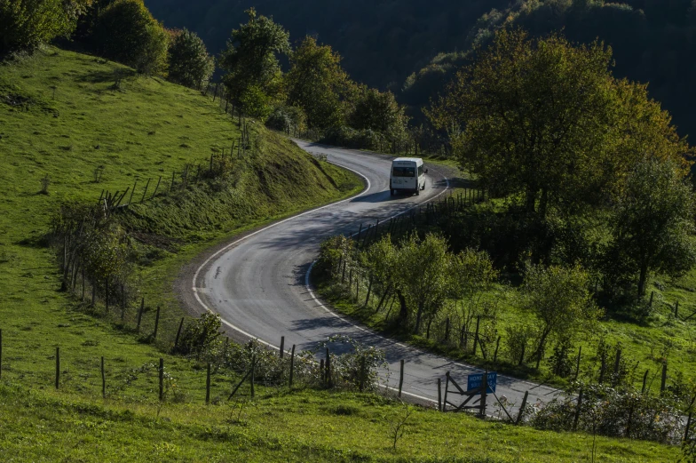 a truck driving down the road on a sunny day