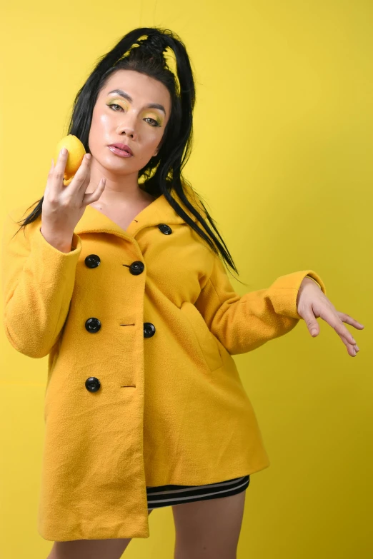 a woman posing wearing a coat and showing her peace sign