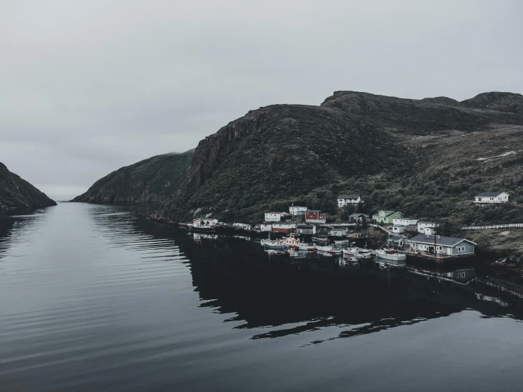 the water is calm and the shore houses are on