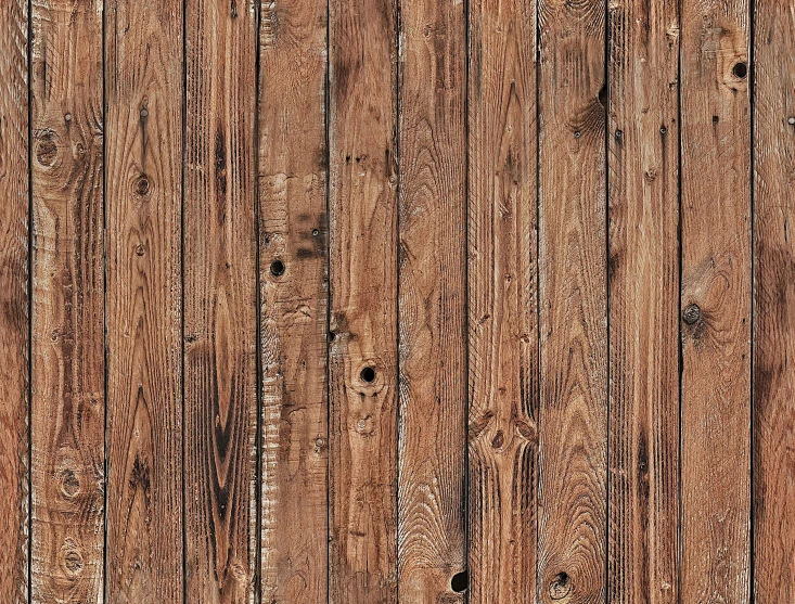 a wood planked wall with brown stain