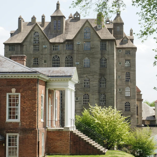 a large brick building next to a couple of trees