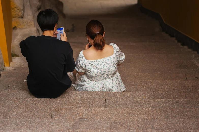 there are two people sitting on the stairs