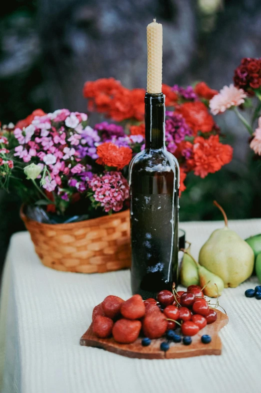 fruit and vegetables on a wooden board near a bottle