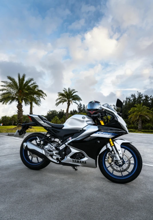 a motorcycle parked on a street with palm trees