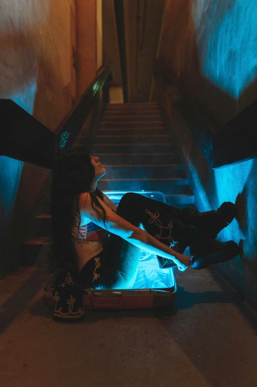 a person lying on a skate board in front of a stairway
