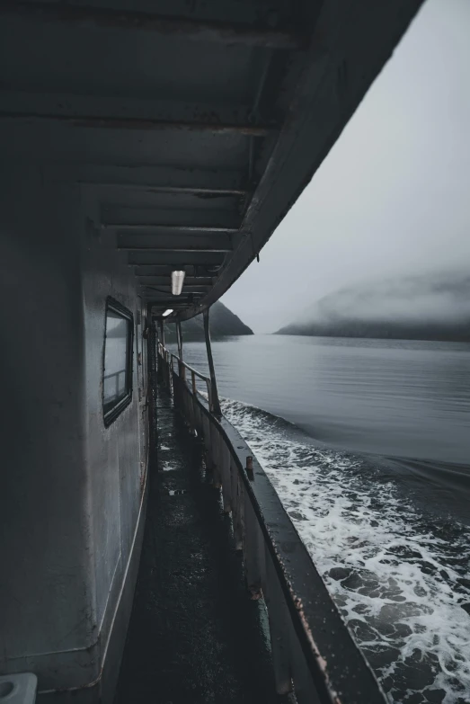 looking down the side of a ship at the water