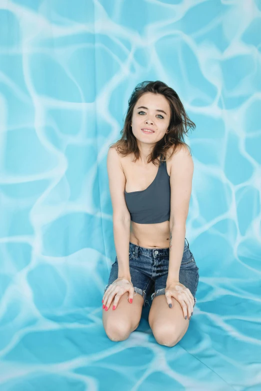 a woman in denim shorts and a crop top