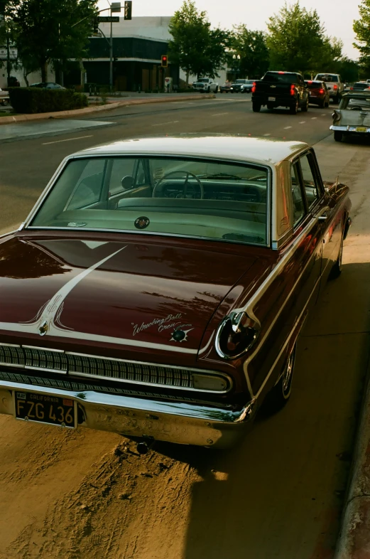 a very old fashioned car sitting out side in a lot