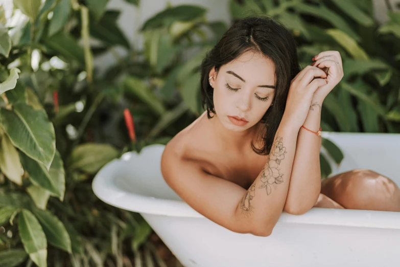 a young woman is taking a bath outside