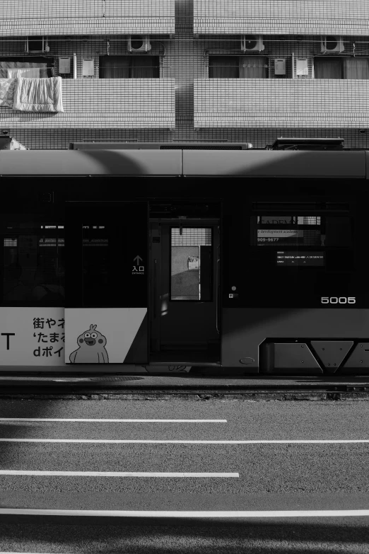 an empty trolley car is in front of some tall buildings