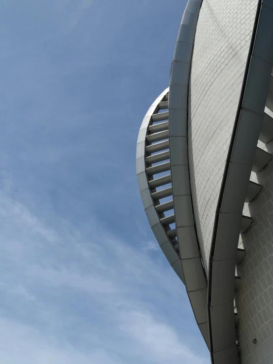 the corner of a building with an arch with a wind indicator