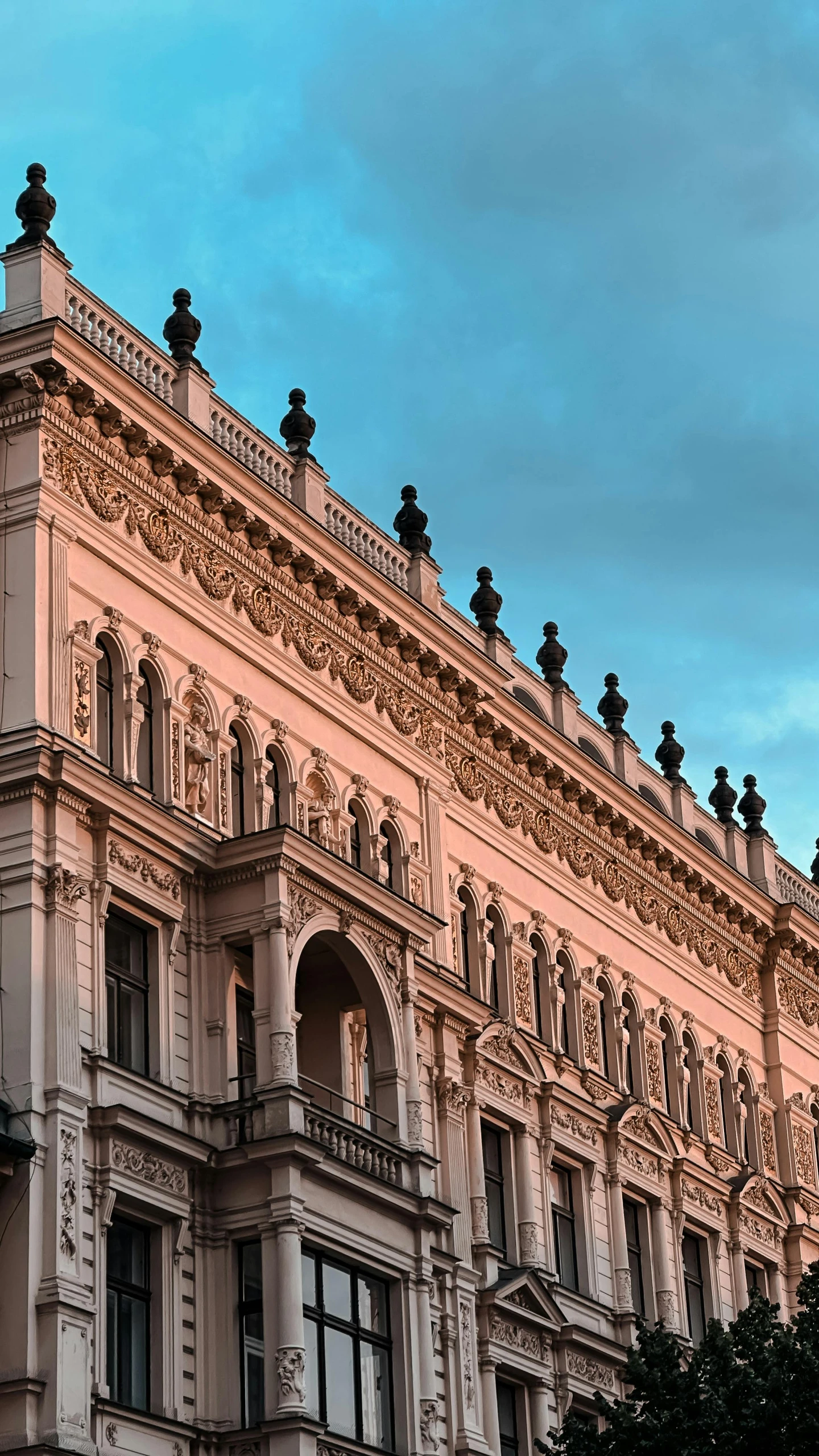 an ornate building with birds on top