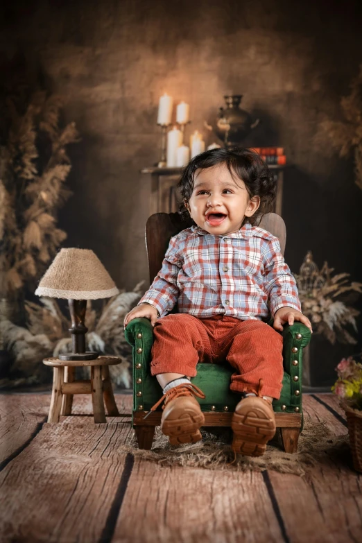 a small  sitting on a green chair and making faces