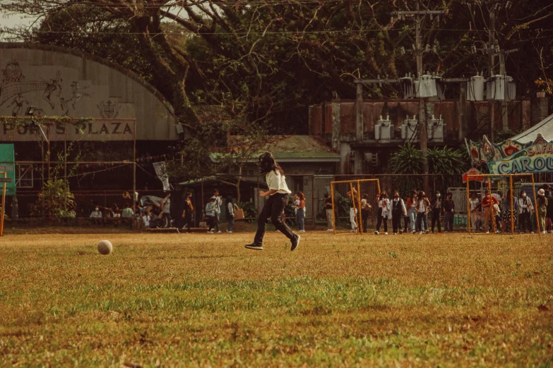 two people are playing soccer in an open field