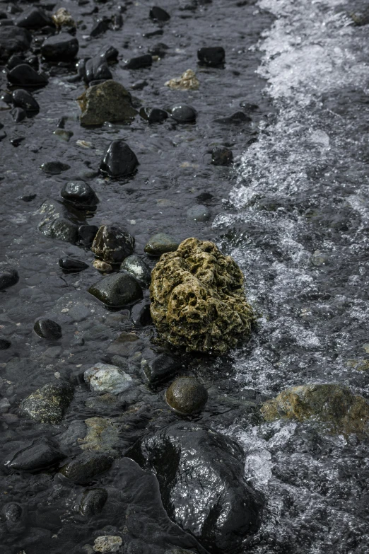 a rock is sticking out of some water