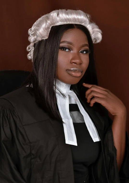 a beautiful young woman posing in front of a judge's chair