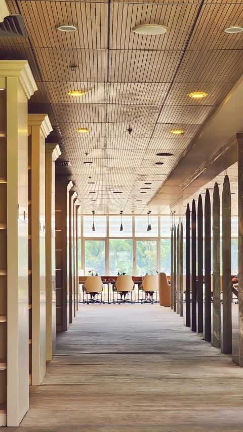 a long, empty office lobby filled with books