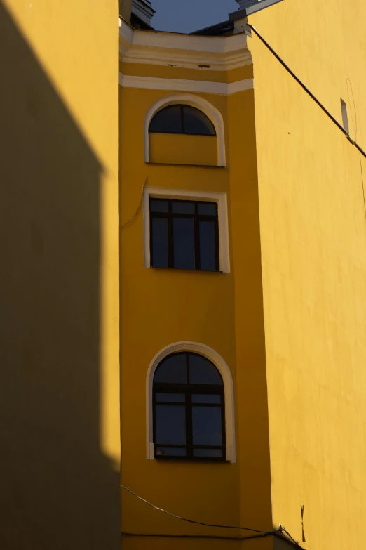 the shadow of a building is cast on the wall