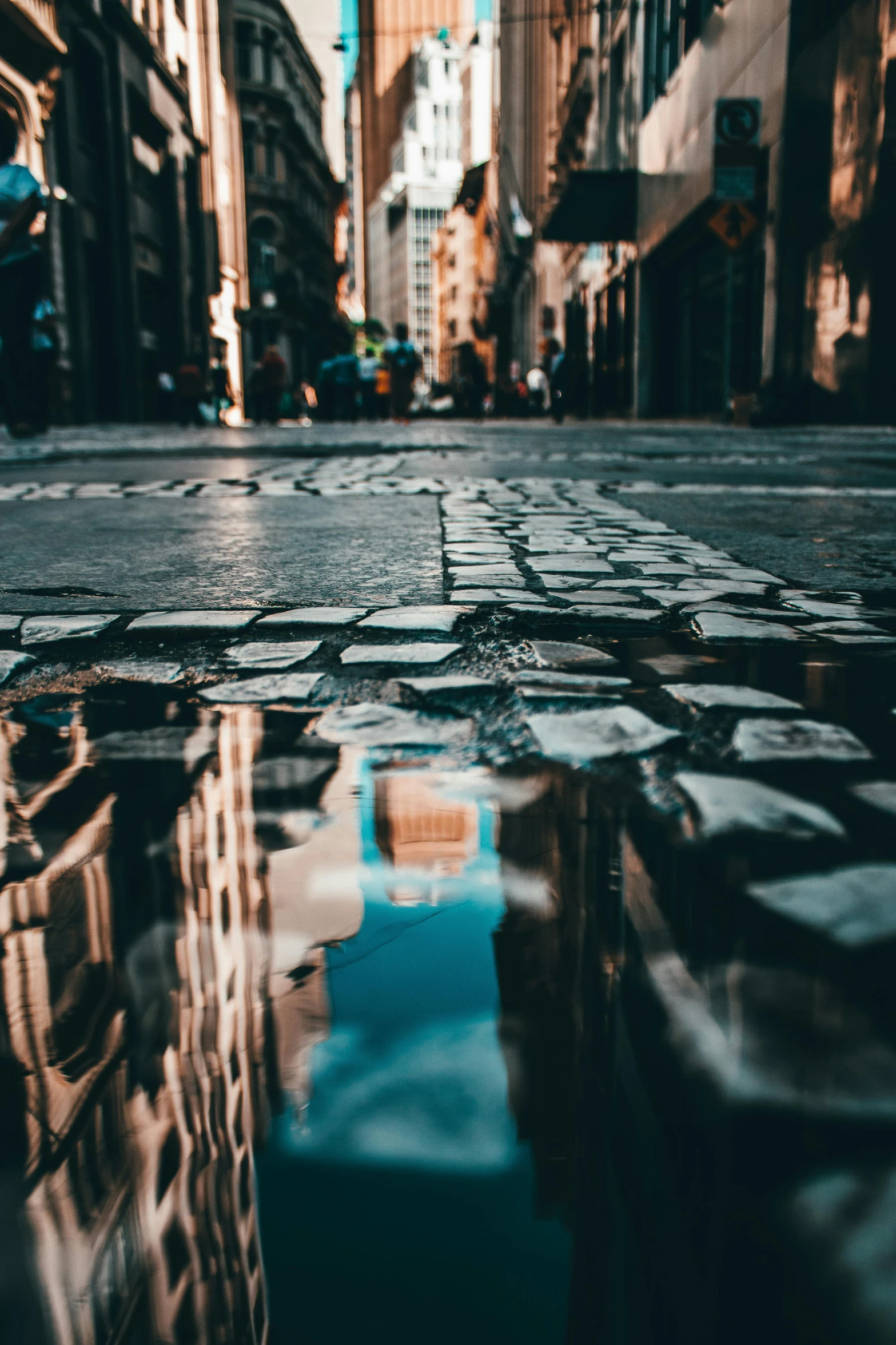 an empty street and some buildings and clouds